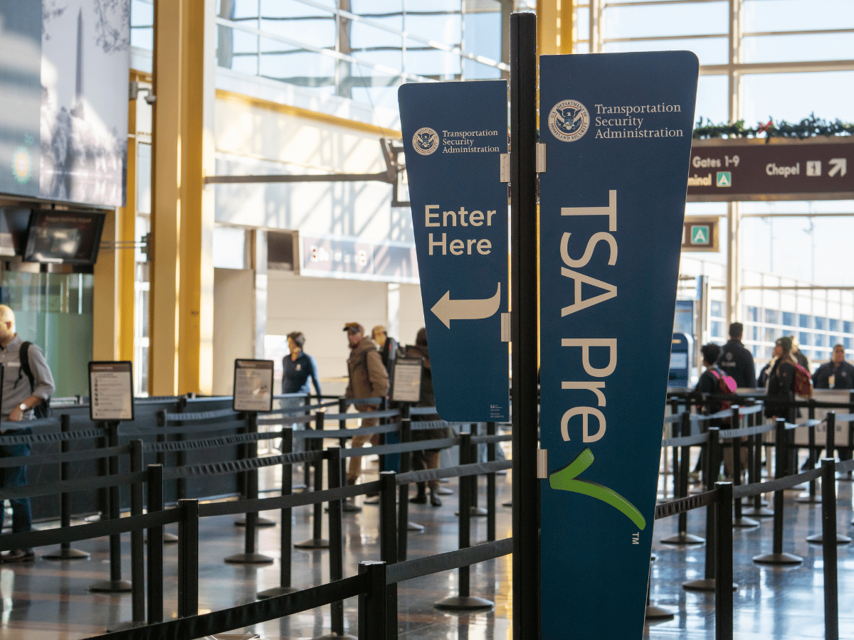 Travelers preparing to pass through airport security screening
