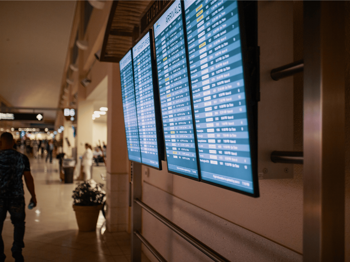 Airport departure board displaying flight information