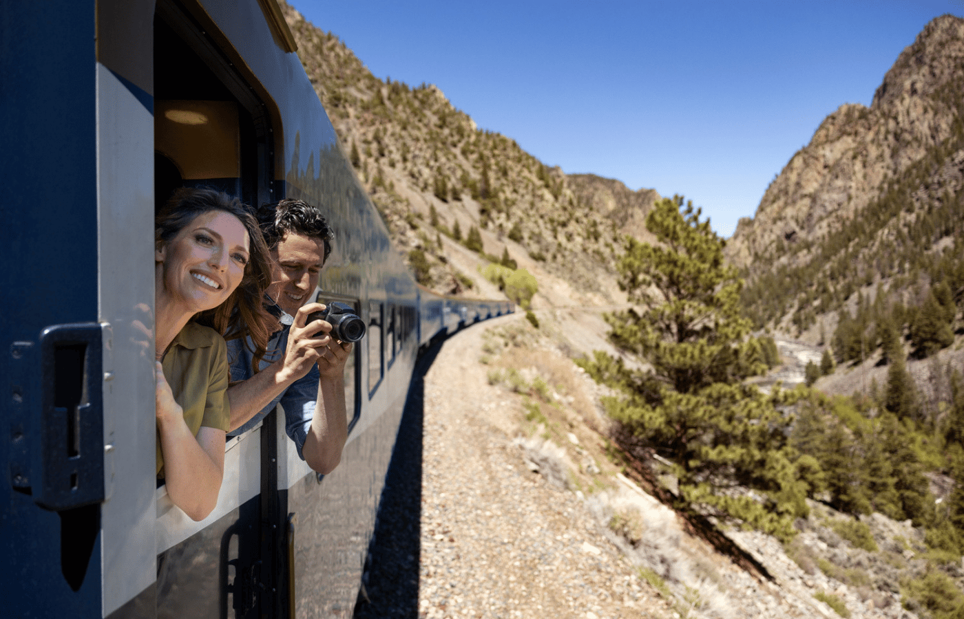 Couple photographing scenery during a Canyon Spirit rail journey