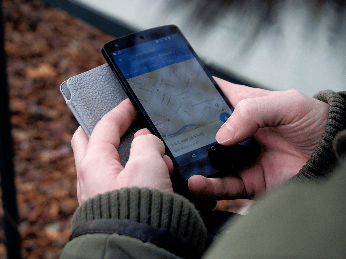 Traveler using a smartphone map while navigating a destination