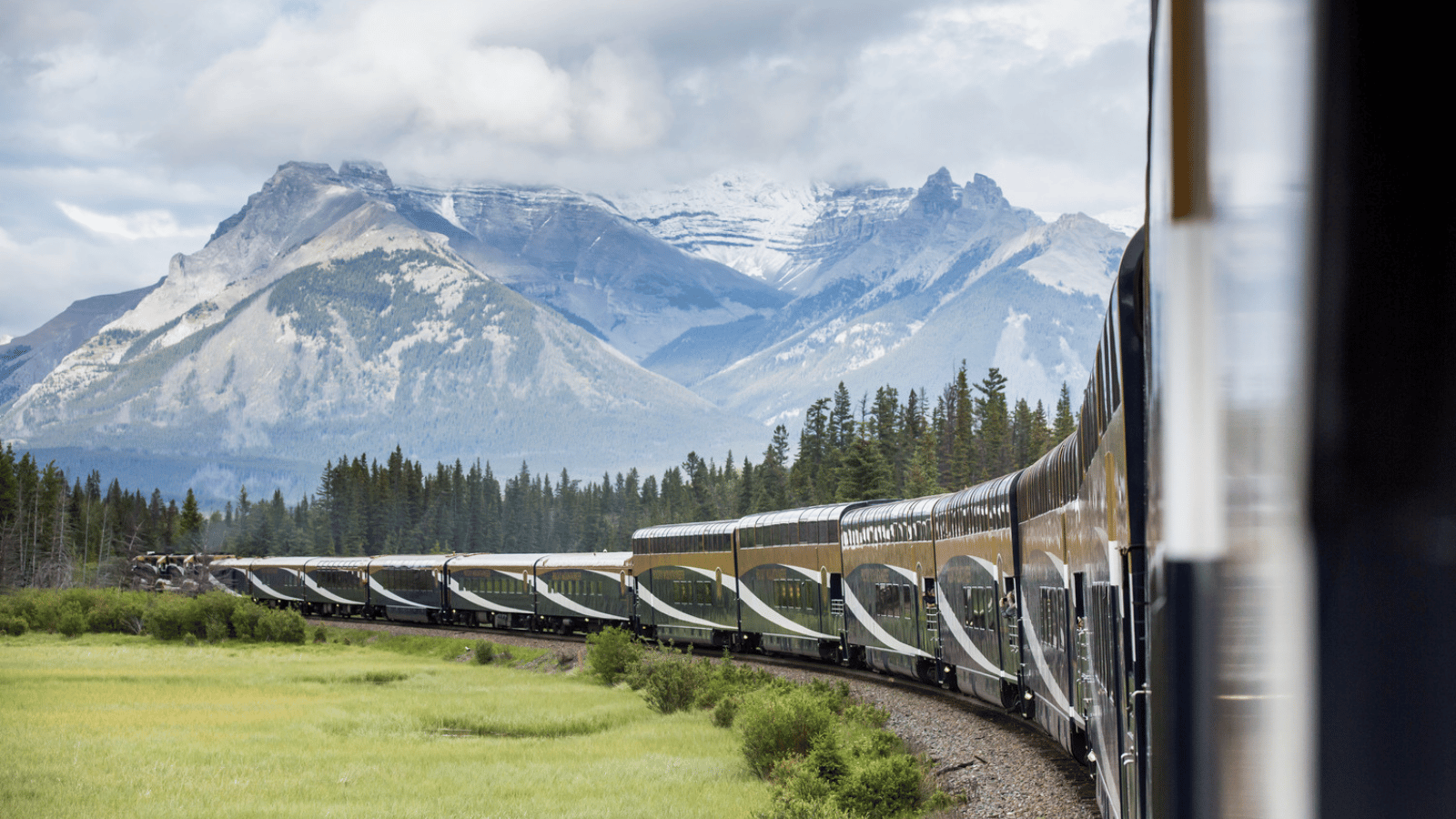 Rocky Mountaineer traveling beneath Mount Girouard